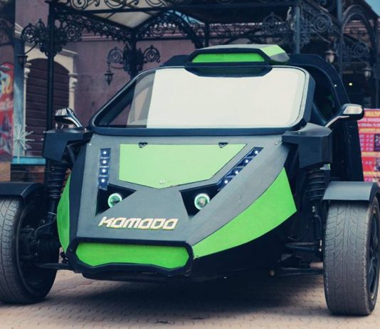 A black and green komodo electric car