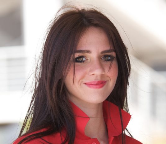 Vodafone to Create 600 Newcastle Jobs Female vodafone employee in a red staff T-shirt with the collar turned up.
