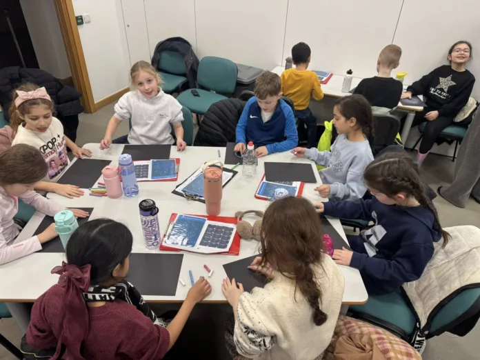 Children take part in a hands-on workshop, creating their own model galaxies as part of the learning experience.